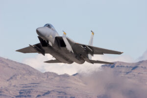 A military jet aircraft taking off.