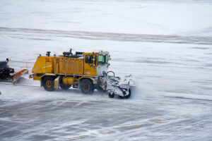 Ground crews clear snow from a taxiway at Denver International Airport