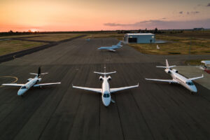 Four private jets parked on the runway