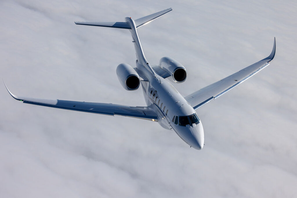 Top view of a Citation X (business jet) over cloud layers