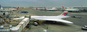 Two British Airways Concorde supersonic jets (one in the distance) stand at their gates | Photo: milehightraveler