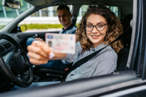 A young driver shows her license