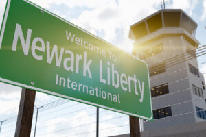 Newark Liberty International Airport Green Road Sign In Front of Air Traffic Control Tower.