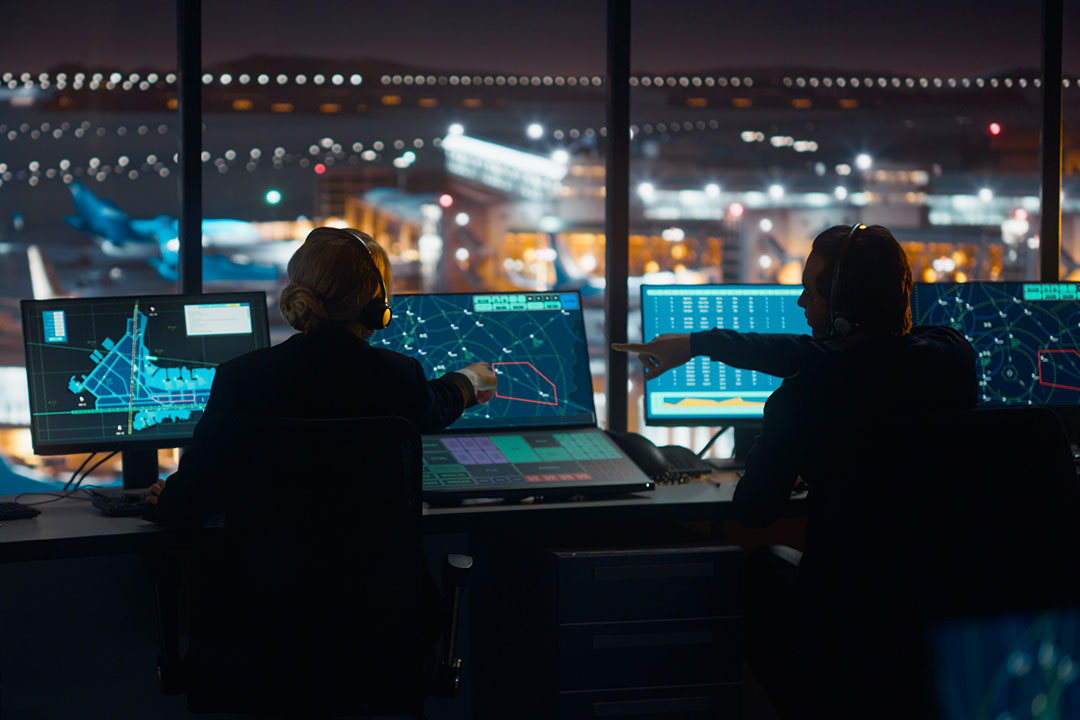 Air Traffic Controls working in a control tower.