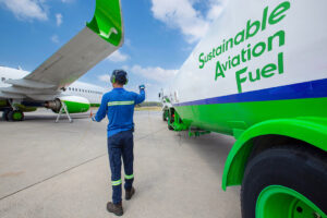 Technician refueling private jet with SAF at the airport.