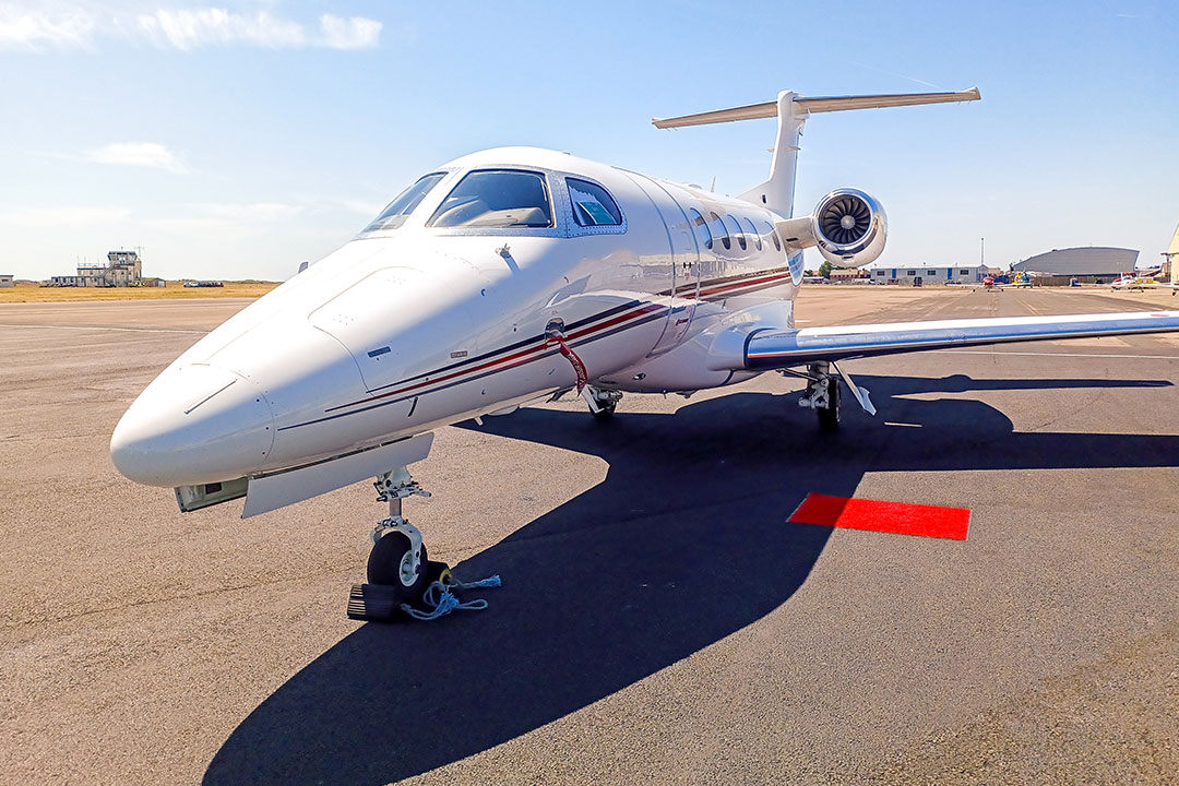 Private jet on tarmac, prepped for immediate departure.