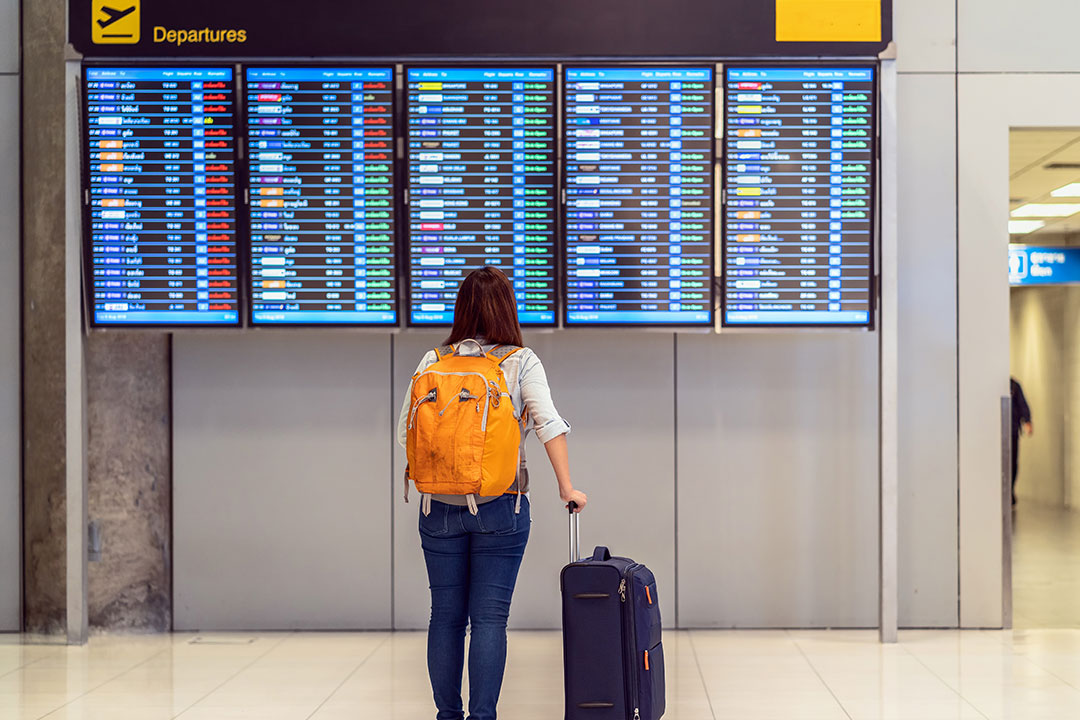 A traveler checks flight departures.