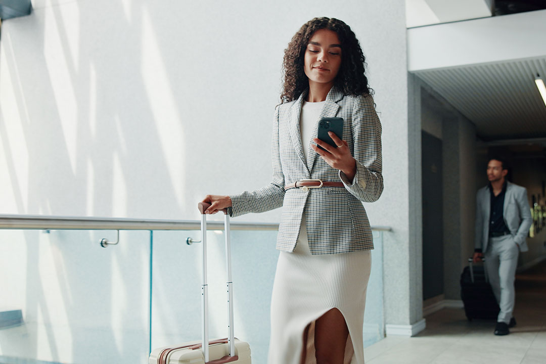 woman checking phone in airport