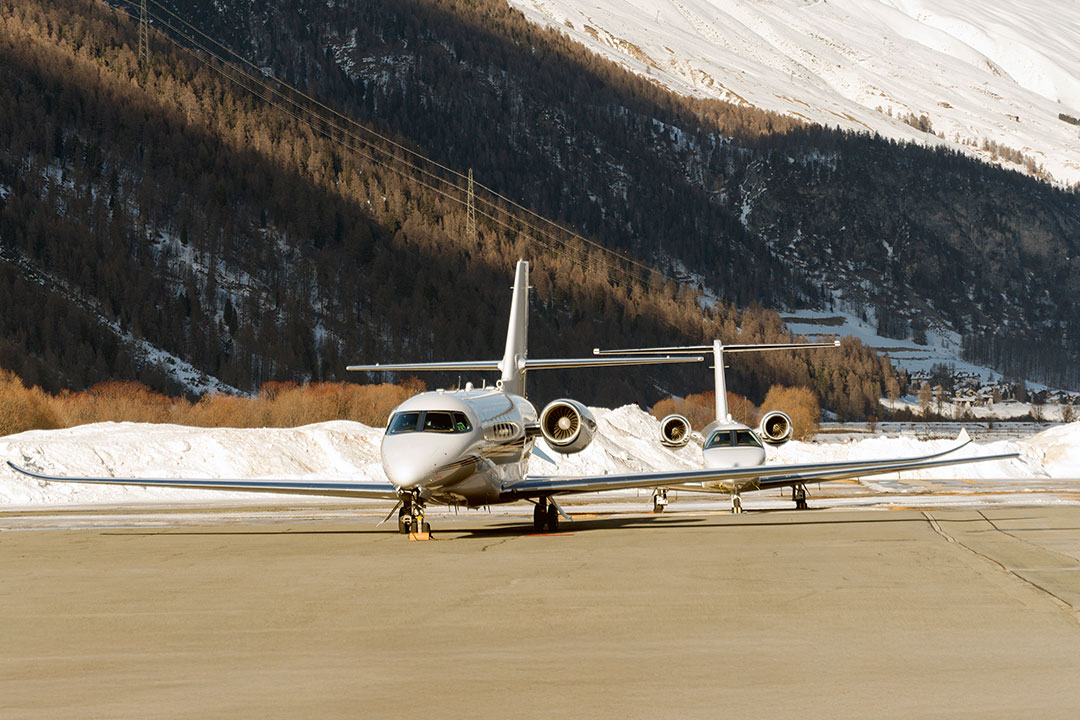 Two private jets taxi at the airport of Engadine, St Moritz.