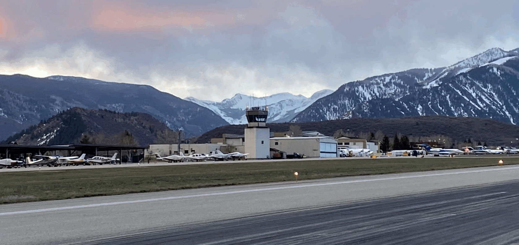 ASE's Air Traffic Control Tower with several small planes and jets parked at terminals. | Photo: aspenairport.com