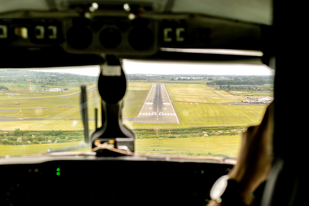 Cockpit view of runway during private jet landing approach
