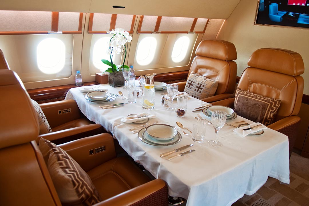 The Ultimate Dining Suite: A sophisticated cabin transformation featuring real china, polished silver, and fine crystal, designed to make your inflight meal a high-end culinary event.
