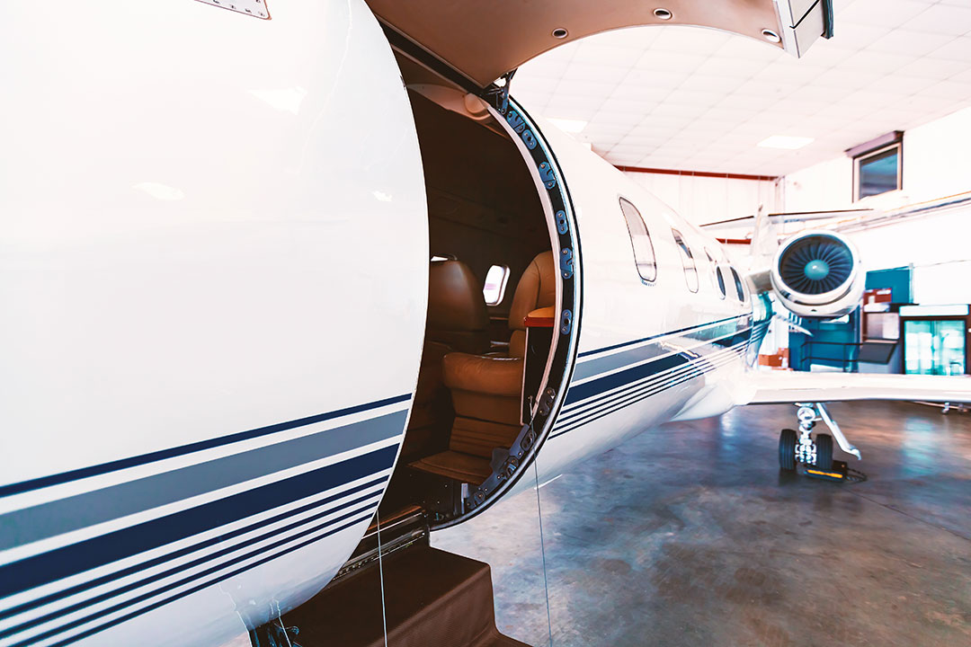 A private jet with an open door at its FBO.