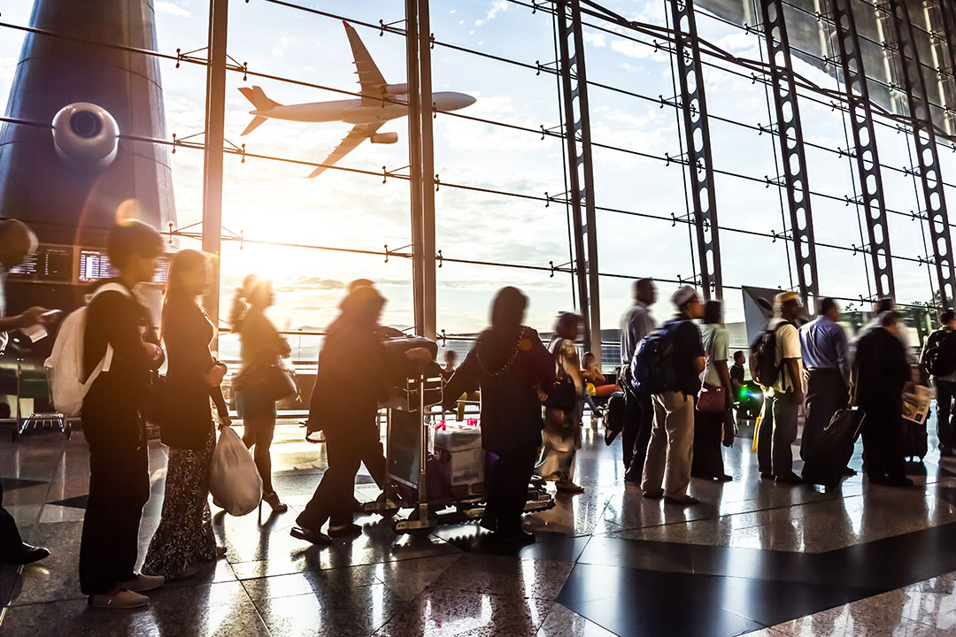 Passengers line up at an airport security checkpoint.